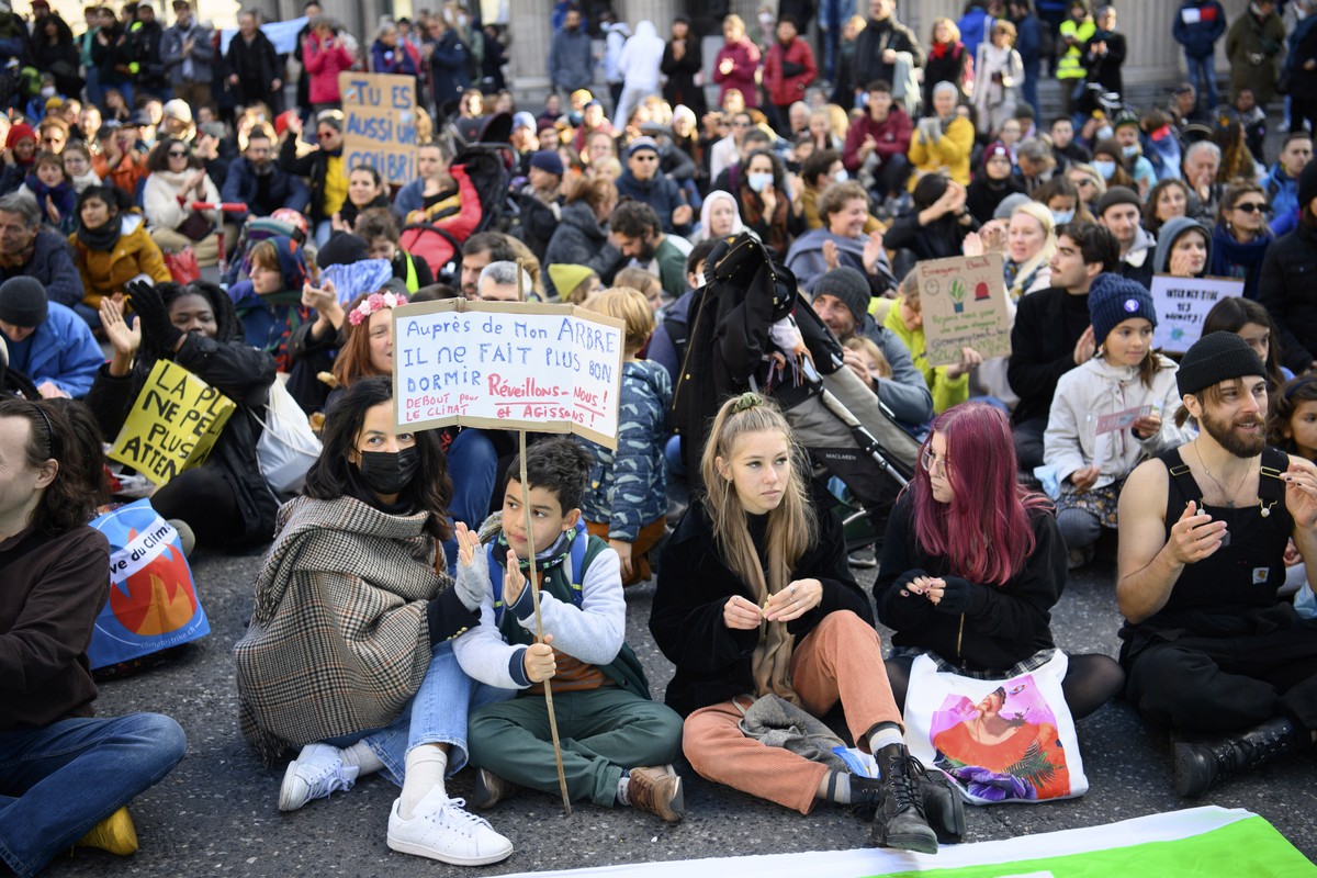 epa09567962 People take part in demonstration '26 years of COP: only words in the air! for a popular ecology!' to demand actions from world leaders against climate change, in Lausanne, Switz ...