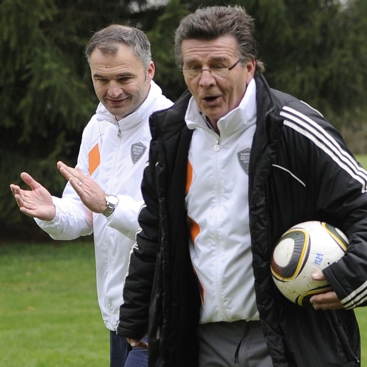 Former Swiss soccer players Stephane Chapuisat, left, and his father Gabet Chapuisat, right, play soccer in a golf course during the Golfoot Masters in Lausanne, Switzerland, Monday, April 16, 2012. T ...