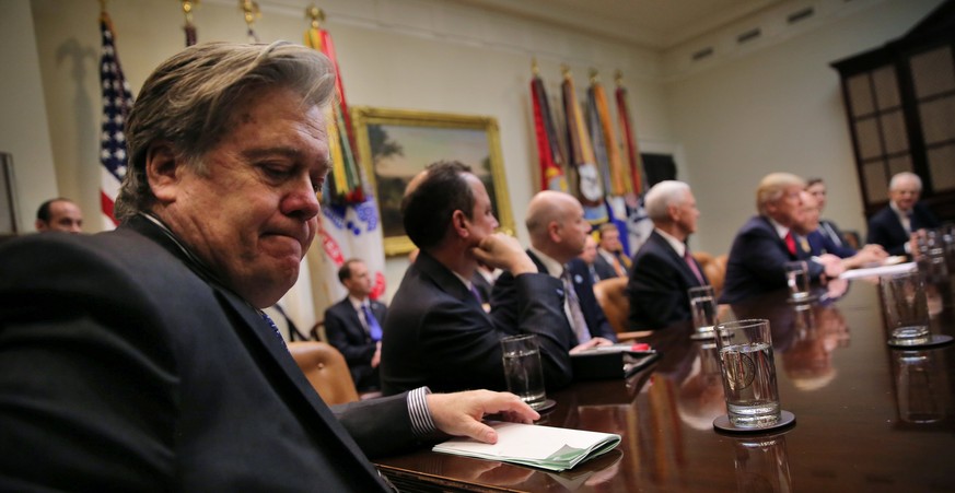 White House Chief Strategist Stephen Bannon (L) attends a meeting between U.S. President Donald Trump and congressional leaders to discuss trade deals at the at the Roosevelt room of the White House i ...