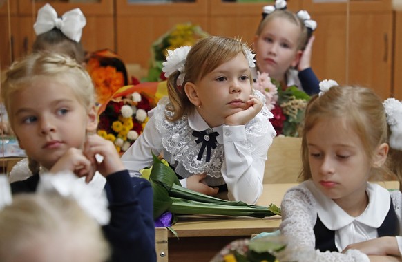 epa09439897 First graders attend their first lesson at a school in Podolsk outside Moscow, Russia 01 September 2021. More than two million children went to the first class in more than 40,000 secondar ...