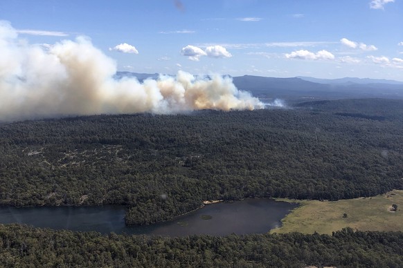 epa11171659 A handout photo made available by the Tasmania Fire Service shows a bushfire burning in Tasmania&#039;s Central Highlands, Australia, 22 February 2024. On 22 February an emergency warning  ...
