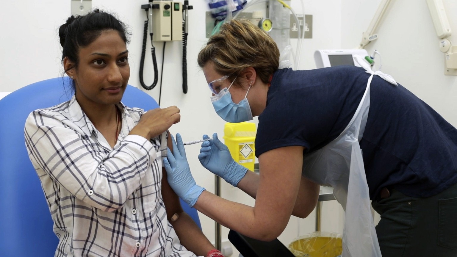 In this screen grab from video issued by Britain&#039;s Oxford University, a volunteer is injected with either an experimental COVID-19 vaccine or a comparison shot as part of the first human trials i ...