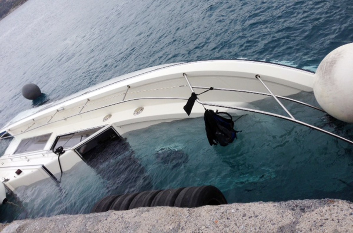 A yacht used to transport immigrants illegally that overturned in a fatal accident is seen at the port of Vathy on the Greek island of Samos, on Monday, May 5, 2014. At least 22 people drowned in the  ...