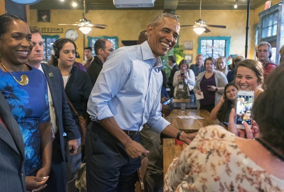 Former President Barack Obama poses for photos during a campaign stop with Illinois Democratic gubernatorial candidate J.B. Pritzker at Caffe Paradiso Friday, Sept. 7, 2018, after speaking on the Univ ...