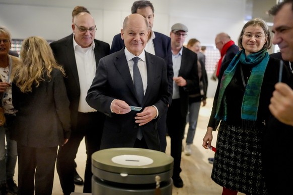 German Chancellor Olaf Scholz casts his ballot during a vote of confidence against him in a plenary session at the German parliament Bundestag, Berlin, Germany, Monday, Dec. 16, 2024. (AP Photo/Markus ...