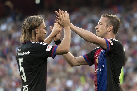 Basel&#039;s Michael Lang, left, and Basel&#039;s Marc Janko, right, cheer after scoring during a friendly soccer match between Switzerland&#039;s FC Basel 1893 and Germany&#039;s VfL Wolfsburg at the ...