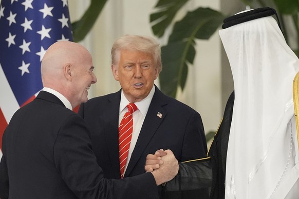 CORRECTS POSITIONS - FIFA President Gianni Infantino, left, gestures as he arrives for a state dinner hosted by Qatar&#039;s Emir Sheikh Tamim bin Hamad Al Thani, right, in honor of US President Donal ...