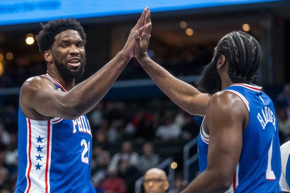 epa10379635 Philadelphia 76ers center Joel Embiid (L) high fives Philadelphia 76ers guard James Harden (R) during the first half of the NBA basketball game between the Philadelphia 76ers and the Washi ...