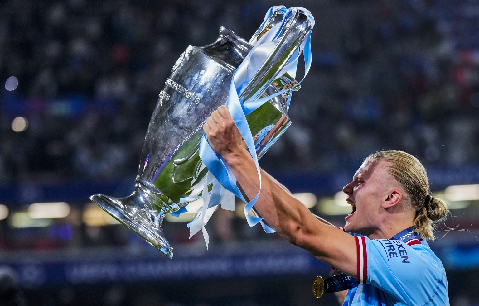 Manchester City&#039;s Erling Haaland celebrates with the trophy after winning the Champions League final soccer match between Manchester City and Inter Milan at the Ataturk Olympic Stadium in Istanbu ...