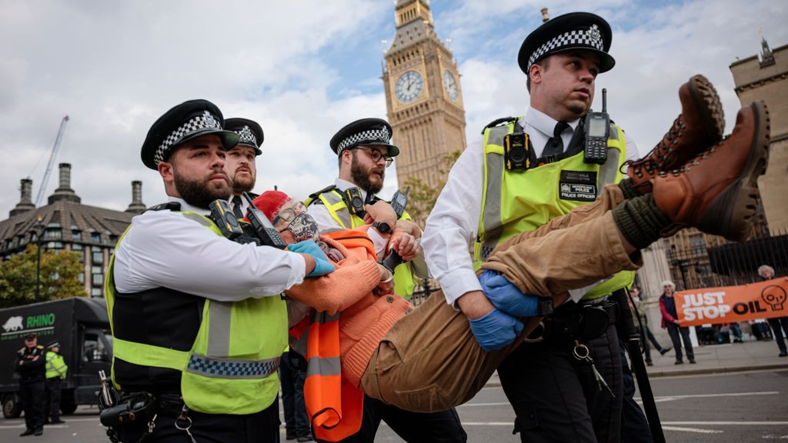 LONDON, ENGLAND - OCTOBER 12: Police officers arrest an Insulate Britain protester at Parliament Square on October 12, 2022 in London, England. Two groups of environmental protesters, Just Stop Oil an ...