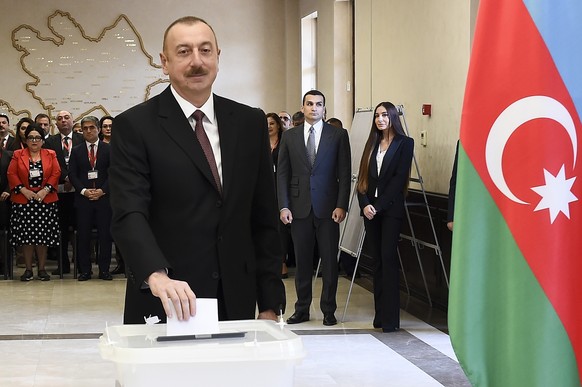 Azerbaijan President Ilham Aliyev casts his ballot at a polling station during presidential elections in Baku, Azerbaijan, Wednesday, April 11, 2018. Voters in the oil-rich Caspian Sea nation of Azerb ...