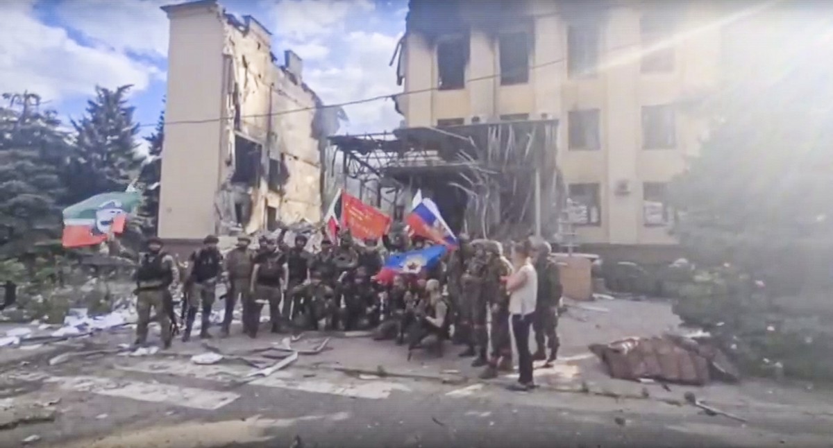 FILE - This photo taken from video provided by Ramzan Kadyrov's Official Telegram channel released on Saturday, July 2, 2022, shows Russian troops including soldiers of Chechen regiment waving Ru ...