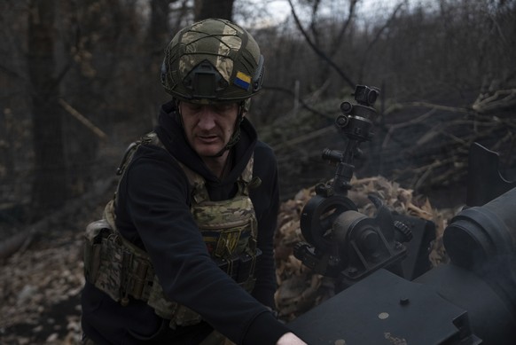 Ukrainian serviceman of Khartia brigade known by call sign &quot;Krystal&quot; check M101 Howitzer after firing towards Russian positions in Kharkiv region, Ukraine, Wednesday, March 12, 2025. (AP Pho ...