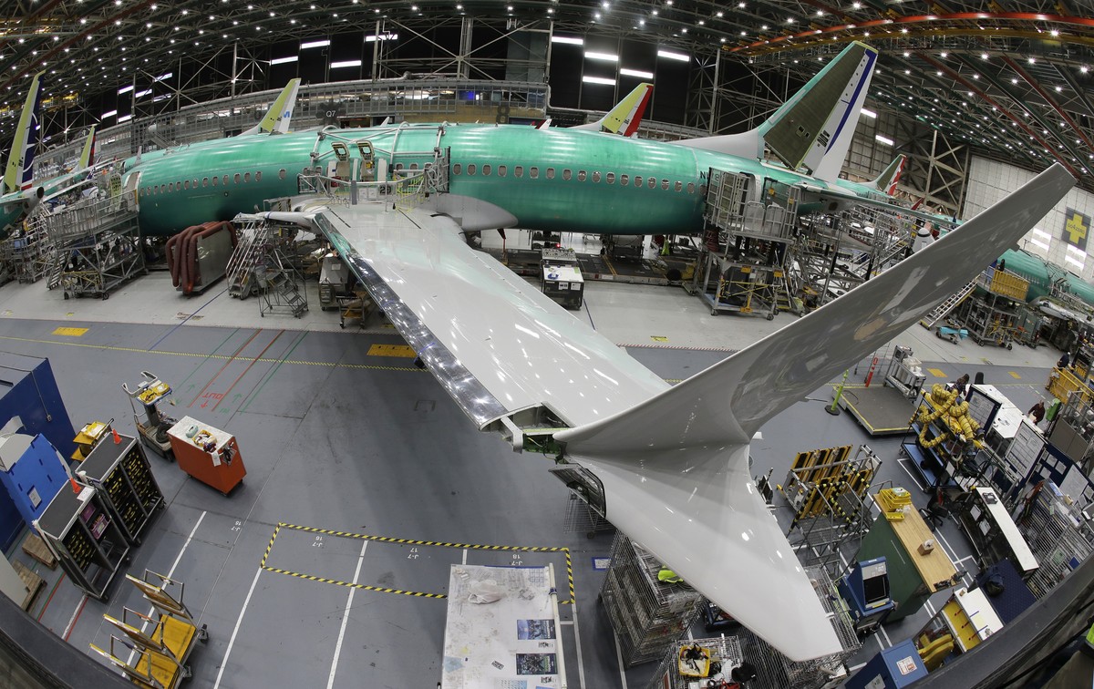 FILE- In this March 27, 2019, file photo taken with a fish-eye lens, a Boeing 737 MAX 8 airplane sits on the assembly line during a brief media tour in Boeing's 737 assembly facility in Renton, W ...