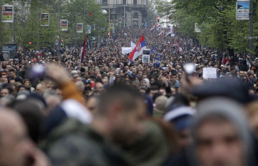 epa07504578 Protesters wave Serbian flags during the protest walk in Belgrade, Serbia, 13 April 2019. Thousands of people protested in Serbia against the President Aleksandar Vucic over what they say  ...