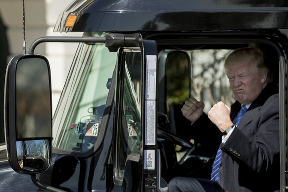 President Donald Trump gestures while sitting in an 18-wheeler truck while meeting with truckers and CEOs regarding healthcare on the South Lawn of the White House in Washington, Thursday, March 23, 2 ...