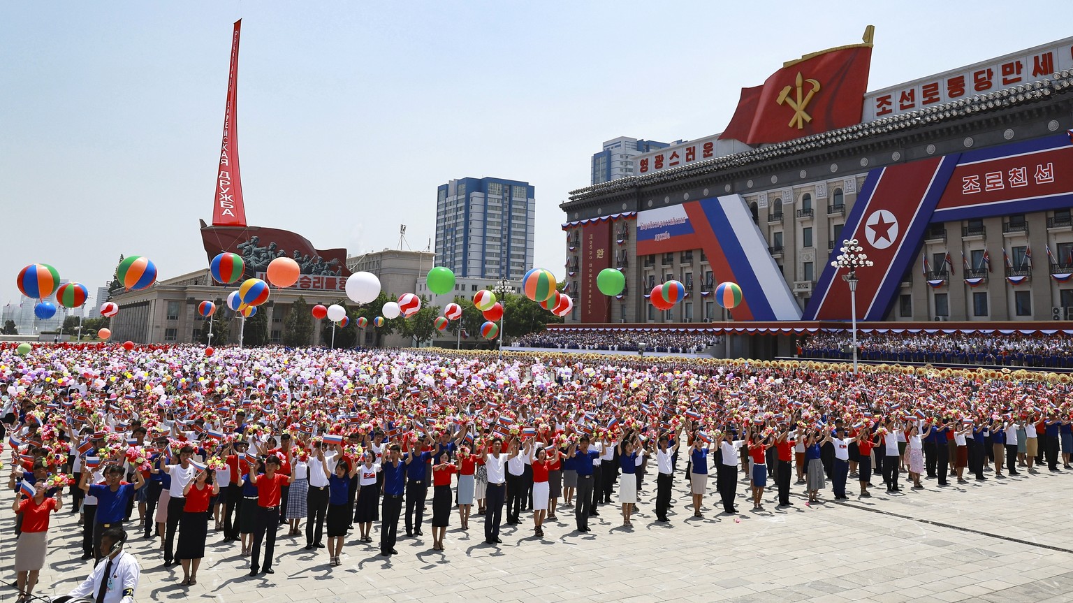 North Korea&#039;s people attend the official welcome ceremony with Russian President Vladimir Putin and North Korea&#039;s leader Kim Jong Un in the Kim Il Sung Square in Pyongyang, North Korea, on W ...