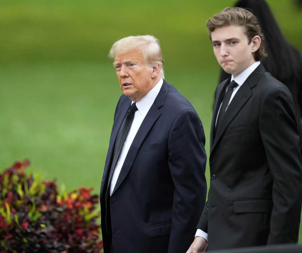 Former President Donald Trump, left, arrives with his son Barron for the funeral of the former first lady's mother at the Church of Bethesda-by-the-Sea in Palm Beach, Fla., Thursday, Jan. 18, 202 ...