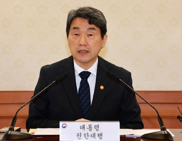 epa12068657 South Korean acting President and Deputy Prime Minister Lee Ju-ho speaks during an emergency meeting of the National Security Council at the government complex in Seoul, South Korea, on 02 ...