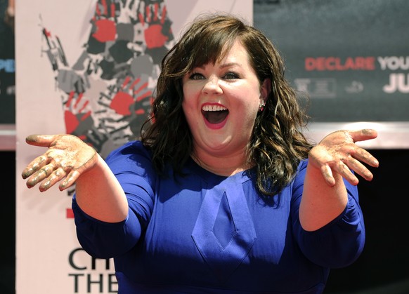 Melissa McCarthy, co-writer and star of the new film &quot;Tammy,&quot; shows off her hands after putting them in cement during a ceremony at the TCL Chinese Theatre on Wednesday, July 2, 2014 in Los  ...