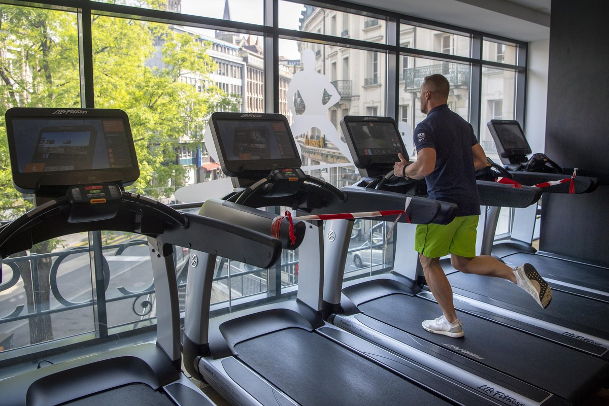 epa08409836 Stijn (last name not given), manager of the gym ''Let's go Fitness'' is running on treadmill during a test workout and the preparations for the reopening after the ...