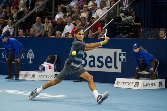 Switzerland&#039;s Roger Federer returns a ball to Argentina&#039;s Juan Martin Del Potro during their final match at the Swiss Indoors tennis tournament at the St. Jakobshalle in Basel, Switzerland,  ...