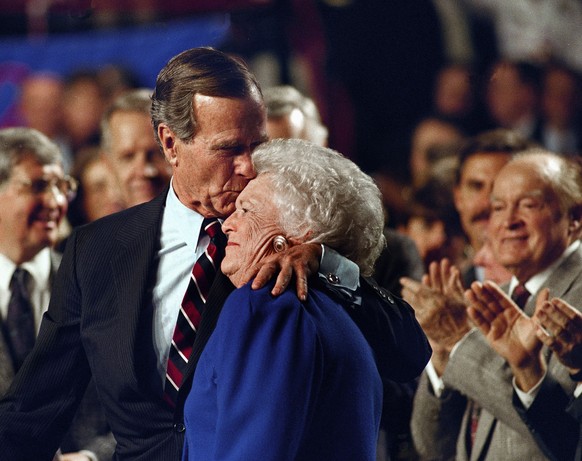 FILE - In this Nov. 2, 1992, file photo, entertainer Bob Hope, back right, applauds as President George H. W. Bush kisses his wife Barbara during a pre-election rally at the Astro Arena in Houston. Fo ...