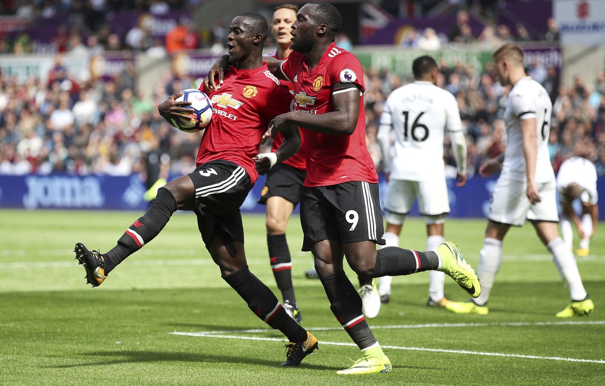 Manchester United's Eric Bailly, left, celebrates with teammate Romelu Lukaku after scoring his side's first goal during their English Premier League soccer match at the Liberty Stadium, Swa ...