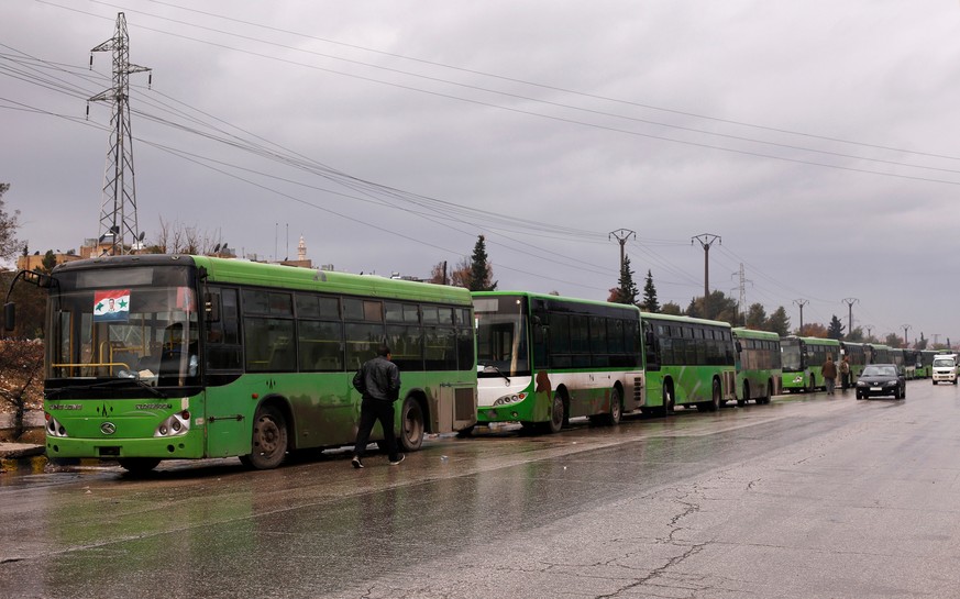 Buses wait to evacuate people from a rebel pocket in Aleppo, in the government-controlled al-Hamadaniah Stadium of Aleppo, Syria December 14, 2016. REUTERS/Omar Sanadiki