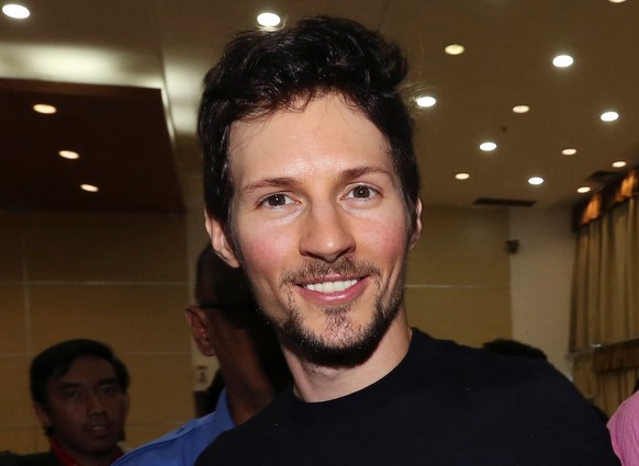 FILE - In this Aug. 1, 2017 file photo, Telegram co-founder Pavel Durov, center, smiles following his meeting with Indonesian Communication and Information Minister Rudiantara in Jakarta, Indonesia. A ...