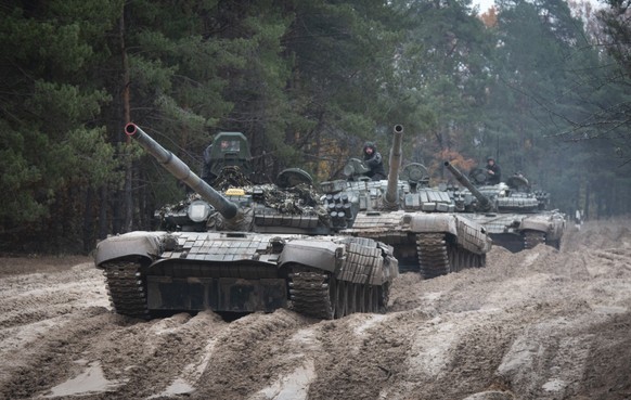 FILE - Ukrainian soldiers on captured Russian tanks T-72 hold military training close to the Ukraine-Belarus border near Chernihiv, Ukraine, Friday, Oct. 28, 2022. (AP Photo/Aleksandr Shulman, File)