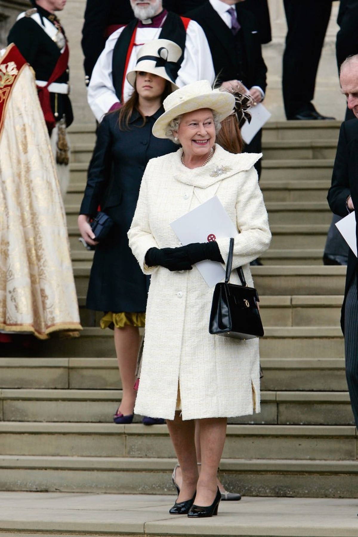 WINDSOR, ENGLAND - APRIL 9: Queen Elizabeth in cream outfit leaves the Service of Prayer and Dedication blessing the marriage of the Prince of Wales, Prince Charles and the Duchess of Cornwall, Camill ...