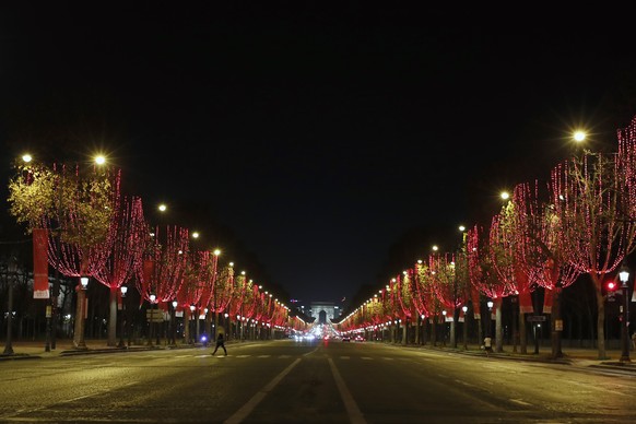 The Champs Elysees avenue with the Arc de Triomphe is illuminated as part of Christmas lightings, In Paris, Wednesday, Nov. 25, 2020. (AP Photo/Francois Mori)