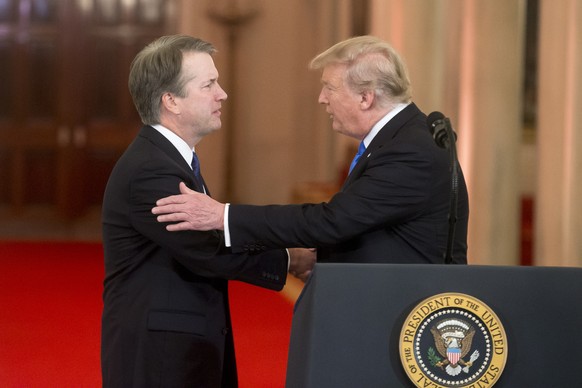 epa06876904 US President Donald J. Trump (R) announces Federal appeals court judge Brett Kavanaugh (L) as his nominee to replace retiring Supreme Court Justice Anthony Kennedy, in the East Room of the ...