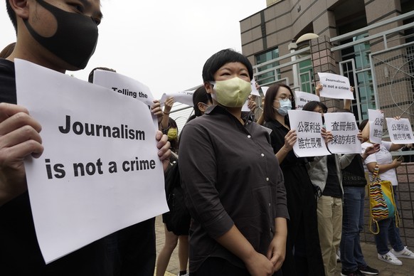 Hong Kong journalist Choy Yuk-ling, second left, poses with supporters before entering a local court in Hong Kong Monday, Nov. 10, 2020. Hong Kong police charged journalist Choy Yuk-ling on charges of ...