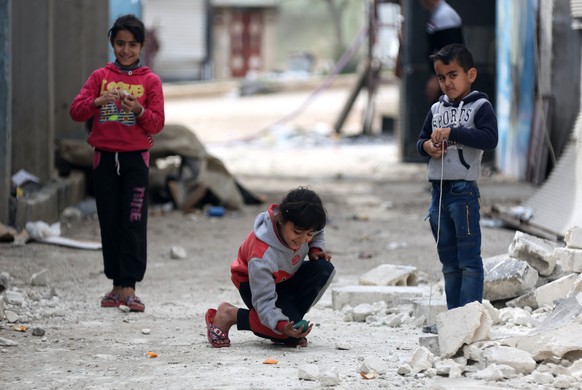 epa06614599 Children play at the recently captured city of Afrin, Syria, 19 March 2018. Turkish President Recep Tayyip Erdogan on 18 March said the Turkish military and allied Syrian militias of the F ...