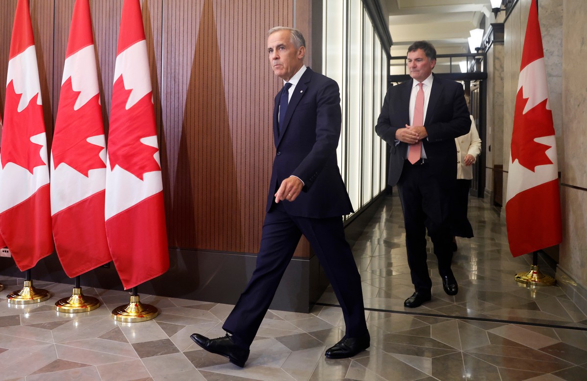 Prime Minister Mark Carney and Canada-U.S. Trade Minister Dominic LeBlanc arrive at a news conference about Canada's response to new U.S. tariffs on Parliament Hill in Ottawa on Saturday, Aug. 22 ...
