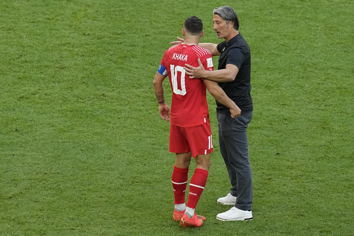 Switzerland's head coach Murat Yakin embraces Switzerland's Granit Xhaka at the end of the World Cup group G soccer match between Switzerland and Cameroon, at the Al Janoub Stadium in Al Wak ...
