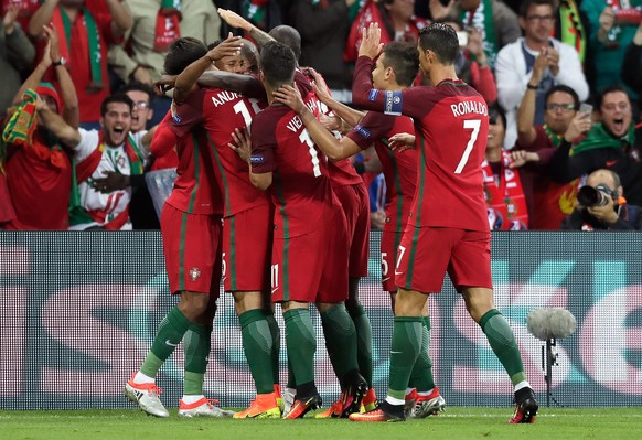 Portugal players celebrate after Nani, 2nd left, scored the opening goal during the Euro 2016 Group F soccer match between Portugal and Iceland at the Geoffroy Guichard stadium in Saint-Etienne, Franc ...