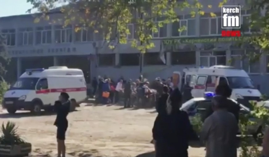 In this image made from video, showing the scene as emergency services load an injured person onto a truck, in Kerch, Crimea, Wednesday Oct. 17, 2018. An explosive device has killed several people and ...