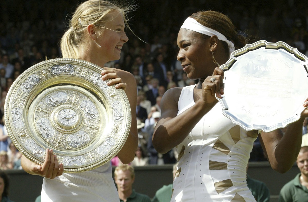 In this Saturday July 3, 2004 file image Russia's Maria Sharapova, left, holds the winner's trophy with Serena Williams holding the runners up trophy after the presentation of the Women' ...