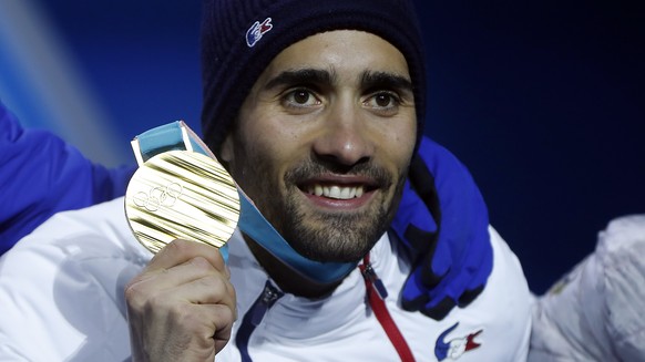 epa06542284 Gold medalist Martin Fourcade of France reacts during medal ceremony for the Men&#039;s Biathlon 15 km Mass Start race at the Alpensia Biathlon Centre during the PyeongChang 2018 Olympic G ...