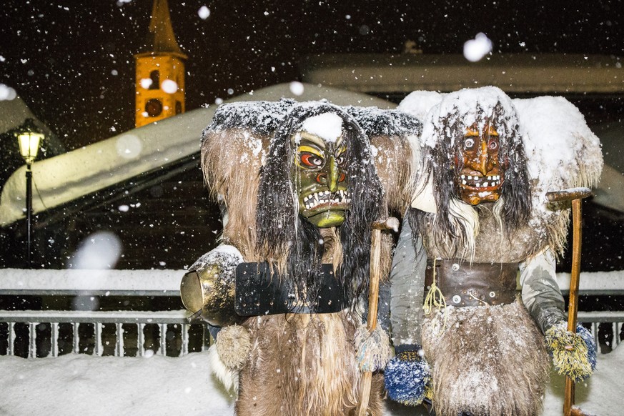 Two &quot;Tschaeggaettae&quot;, masked participants of the traditional carnival cortege, pose in the streets of the village of Kippel in the Loetschental valley, southwestern part of Switzerland, late ...