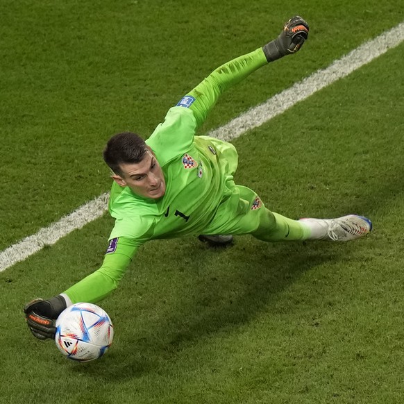 Croatia&#039;s goalkeeper Dominik Livakovic saves a penalty kick by Japan&#039;s Kaoru Mitoma during the World Cup round of 16 soccer match between Japan and Croatia at the Al Janoub Stadium in Al Wak ...