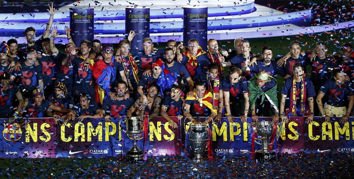 Barcelona's players and staff members pose with their trophies during celebration parade at Camp Nou stadium in Barcelona, Spain, June 7, 2015. Barcelona were crowned kings of Europe for the fift ...