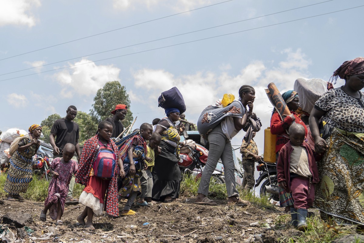 Thousands who are fleeing the ongoing conflict between government forces and M-23 rebels reach the entrance the Democratic Republic of Congo eastern city of Goma Wednesday, Feb. 7, 2024. (AP Photo/Mos ...