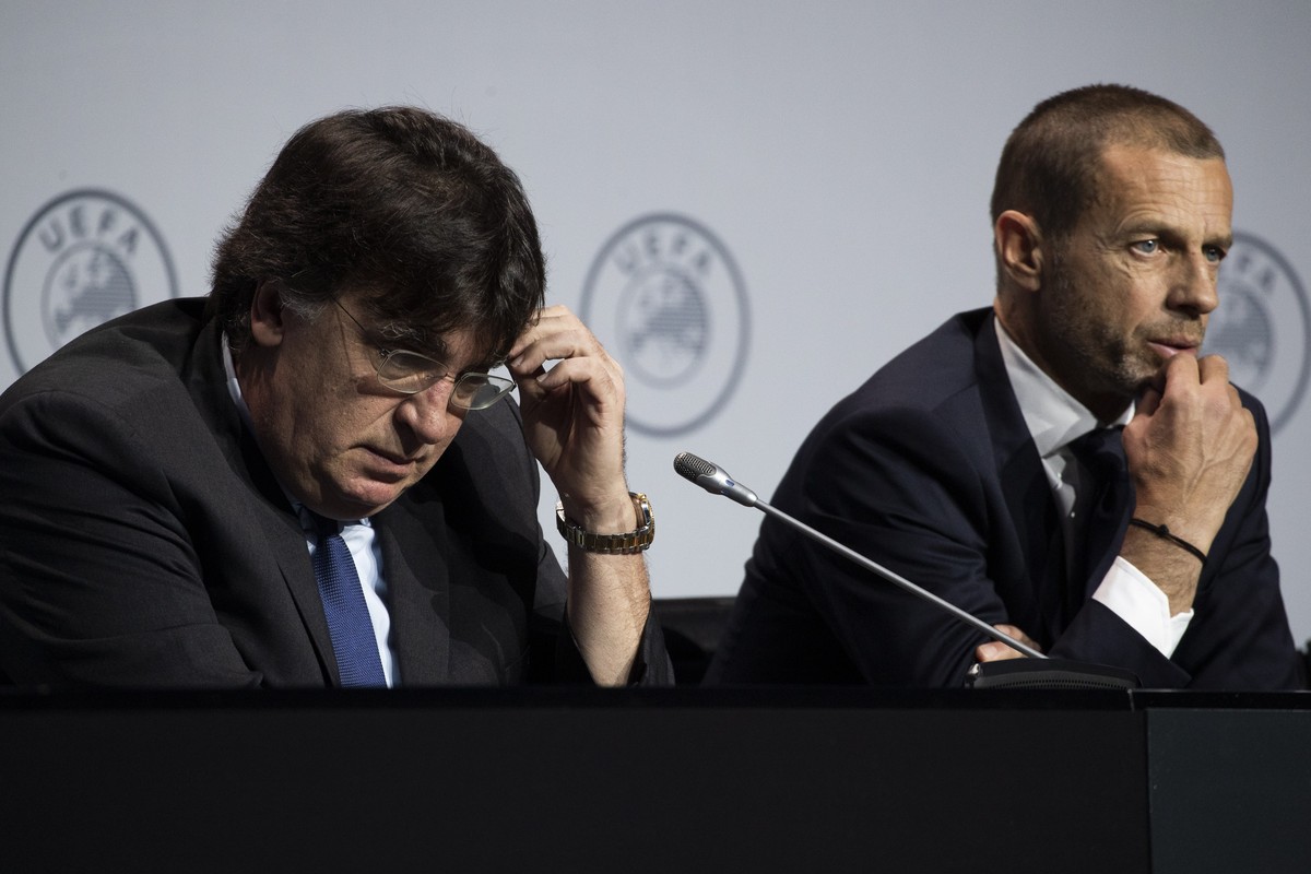 UEFA's Interim General Secretary Theodore Theodoridis, left, and President Aleksander Ceferin, right, answer questions on the virus outbreak following a meeting of European soccer leaders at the  ...