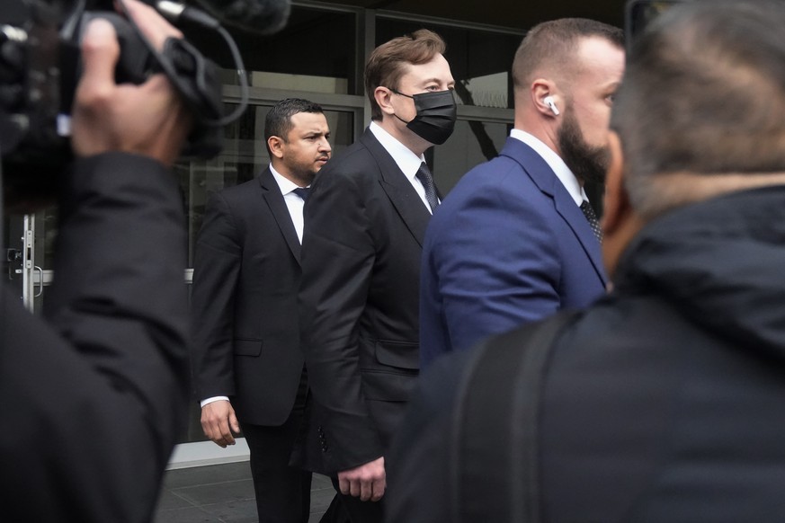 Elon Musk, middle, leaves a federal courthouse in San Francisco, Friday, Feb. 3, 2023. A high-profile trial focused on a 2018 tweet about the financing for a Tesla buyout that never happened drew a su ...