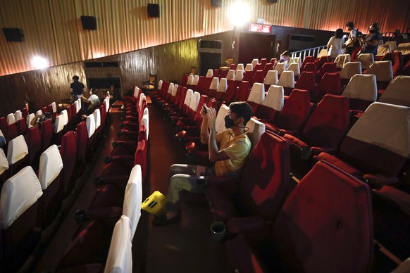 epa08526054 People wearing face masks wait for the start of a screening at the soon-to-close-down Scala movie theater in Bangkok, Thailand, 04 July 2020. After more than half a century since its incep ...