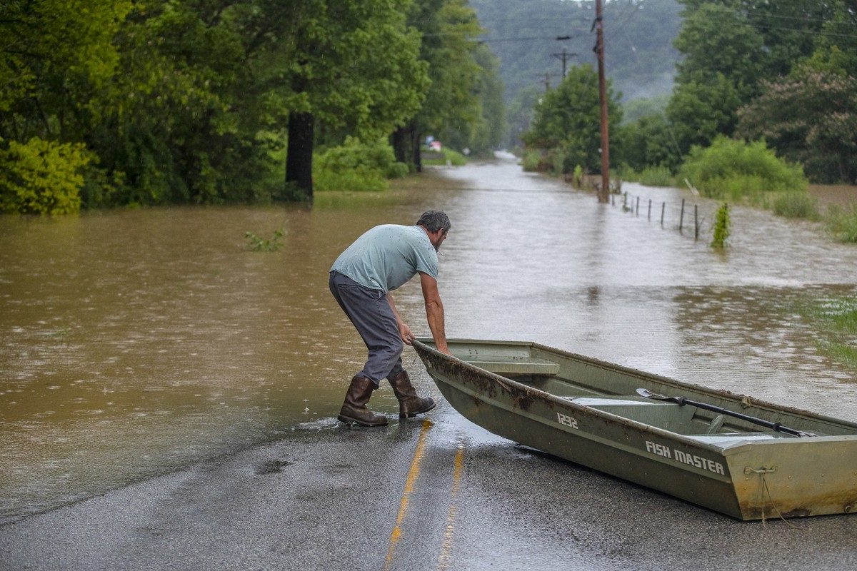 A man prepares to launch a boat near flooded Wolverine Road in Breathitt County, Ky., on Thursday, July 28, 2022. Heavy rains have caused flash flooding and mudslides as storms pound parts of central  ...
